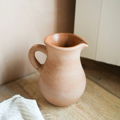 Hand-thrown terracotta jug on rustic dining table
Terracotta ceramic jug filled with fresh flowers
Rustic terracotta jug for summer entertaining
Handmade terracotta pitcher for sangria and drinks
Decorative ceramic jug with earthy terracotta finish
Artisan terracotta jug styled on kitchen shelf
Mediterranean style terracotta jug for home decor
Rustic flower jug with freshly picked garden stems