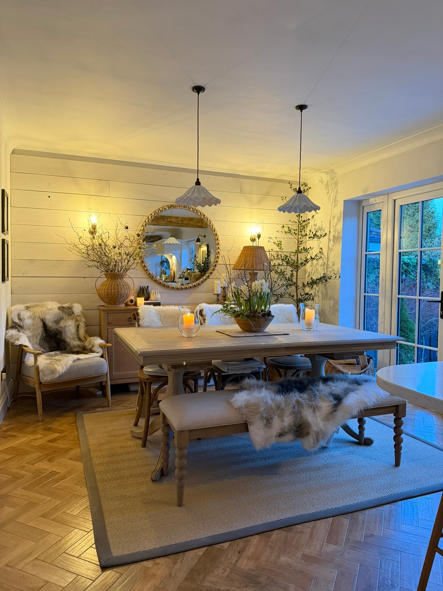 Living room with a dining table, chairs, and decorative elements.