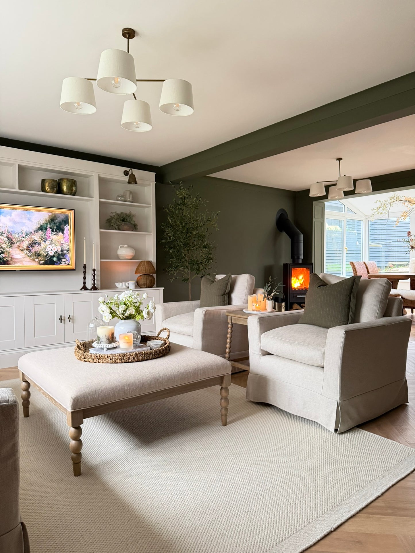 Modern living room with gray sofa, ottoman, and decorative items.