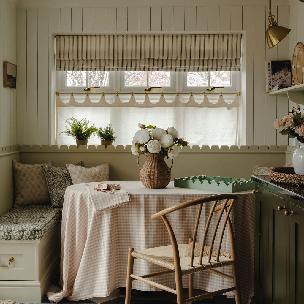 Nestled nook with a table, chairs, and decorative elements in a home setting.