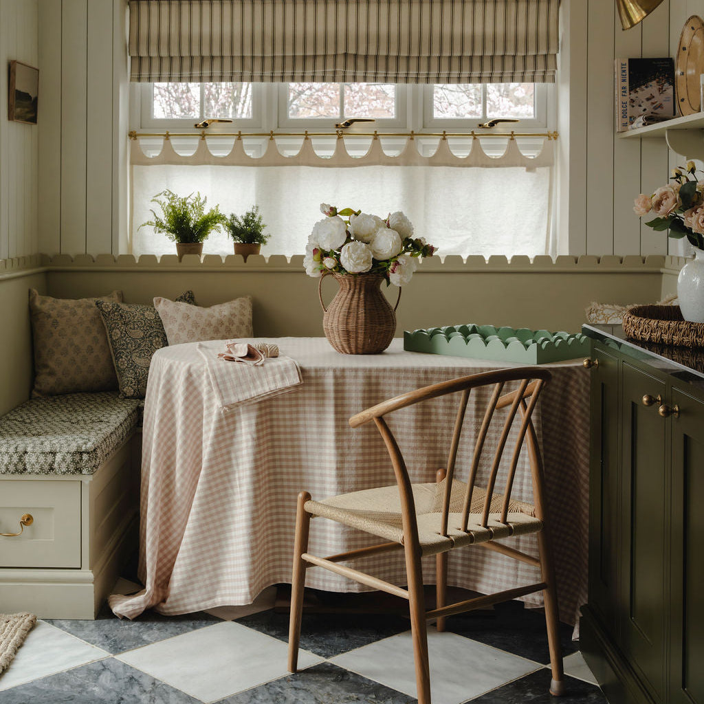 Nestled nook with a table, chairs, and decorative elements in a home setting.