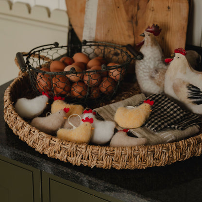 Wicker basket with eggs and toy chickens on a kitchen counter