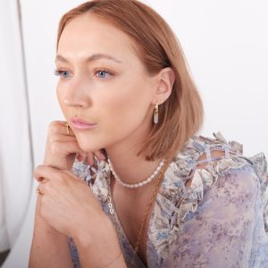 model wearing white quartz crystal hoop earrings